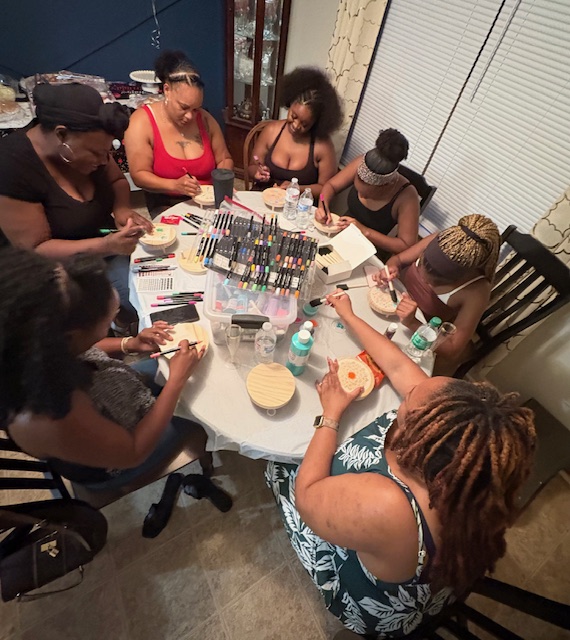 Guests painting plant/candle stands at a Make & Mingle party